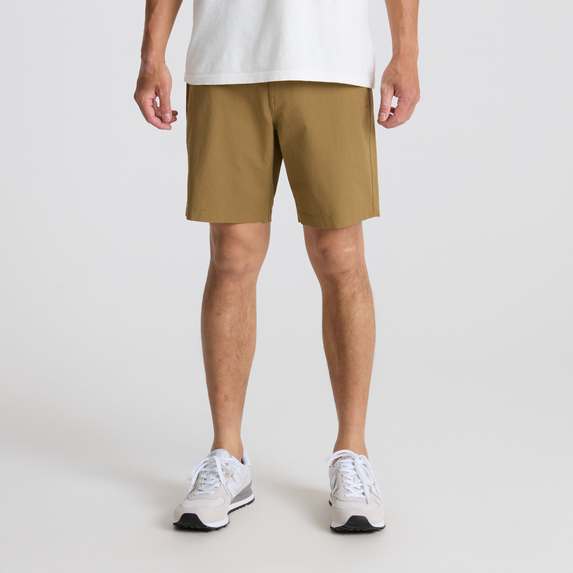 Man wearing Roark's active Bermuda shorts while exploring outdoors, showcasing the calf-length cut ideal for adventure travel.